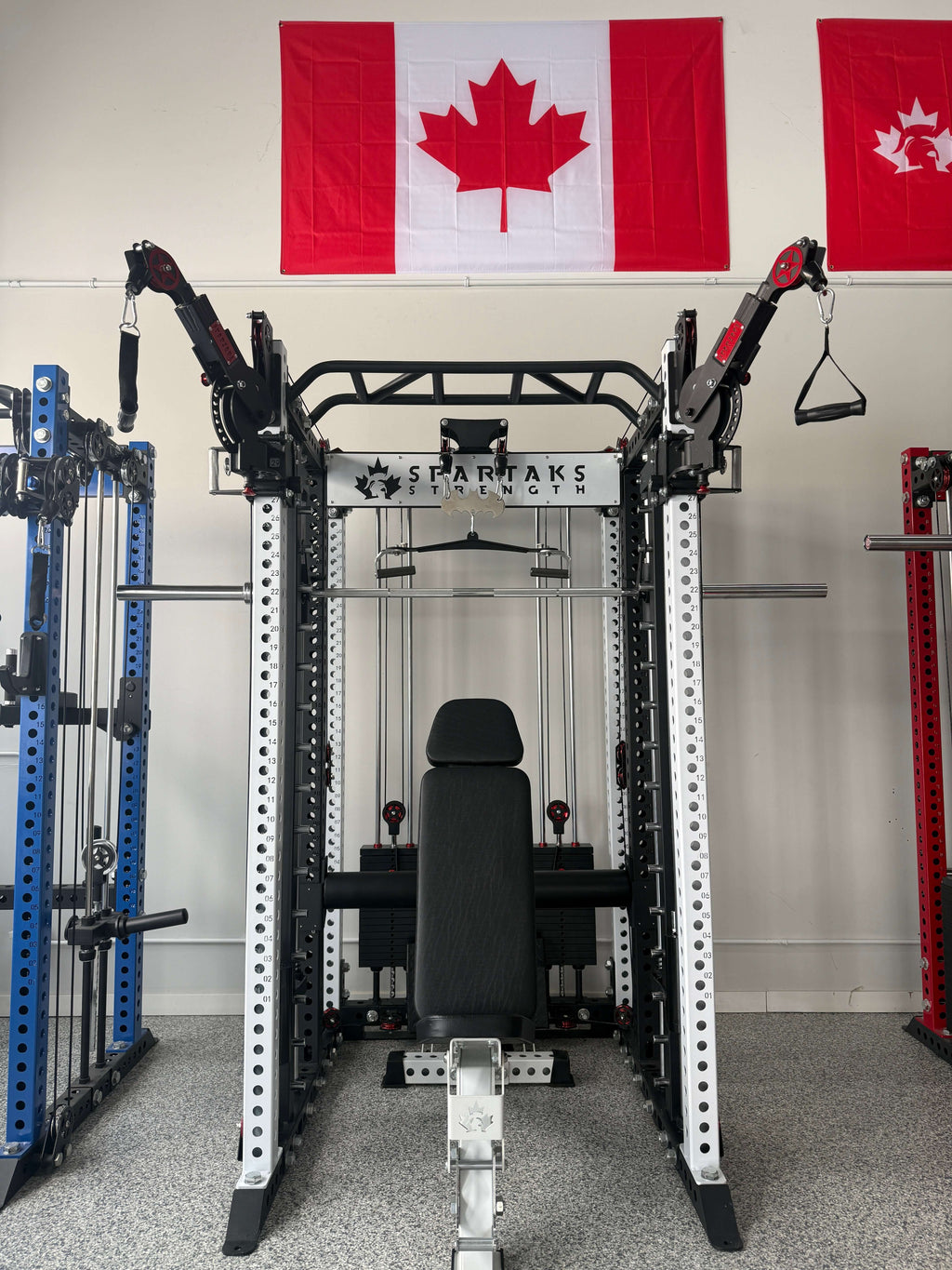 Spartaks Strength KB2406 6-Post Full Rack Functional Trainer (3”×3”, 9-Gauge Steel) in gym with Canadian flags.