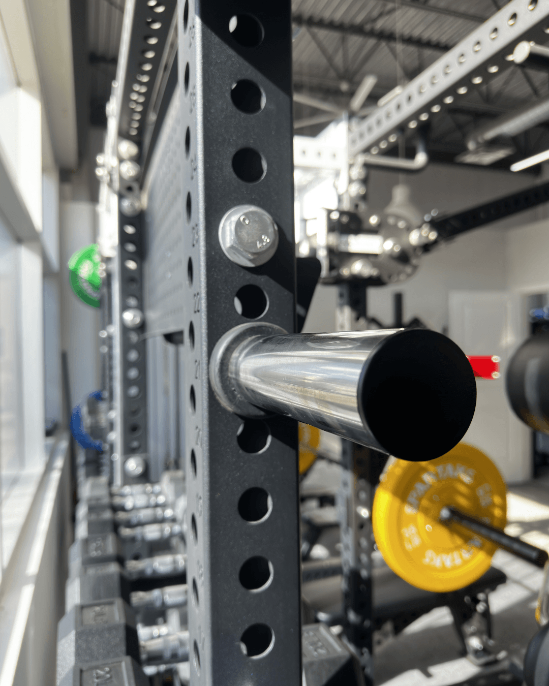 Spartaks Strength Weight Plate Holders (3"x3", 1" Hole) – Pair with Bolts (Set of 2) mounted on gym rack.