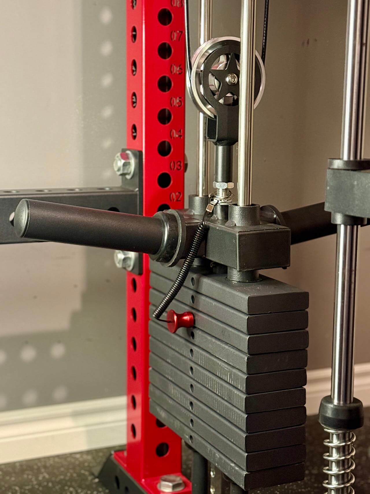 Spartaks Strength KB24 Regular Weight Stack ($2.50/lb) with adjustable weights and cable system in a home gym setup.