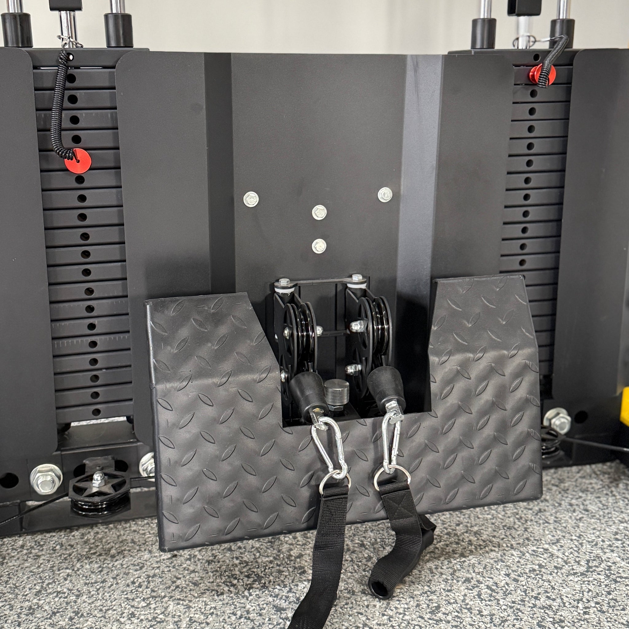 Textured metal footplate for functional trainer attached to a double weight stack and dual pulleys