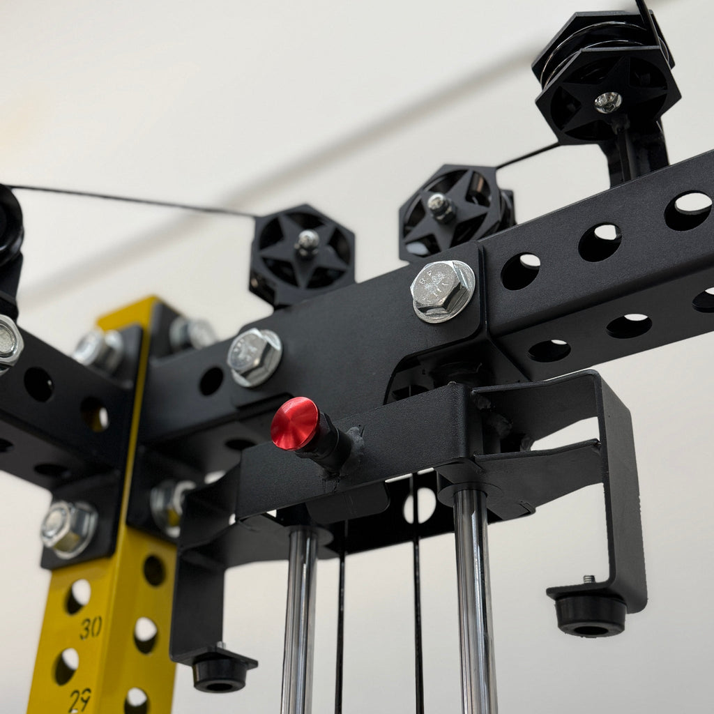 Close-up of a mechanical pulley system with numbered yellow bars on a white background