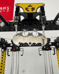 Spartaks Strength Silver 2-to-1 Cable Adapter attached to cable machine for enhanced workout resistance.
