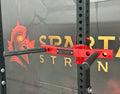 Spartaks Strength Y-Shape One Piece Dip Station (Adjustable Width) on a gym rack for strength training.
